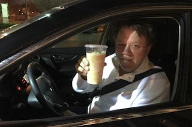 DJ in car with coffee