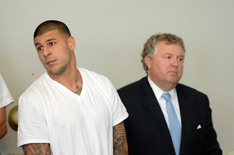 Jun 26, 2013; North Attleborough, MA, USA; New England Patriots former tight end Aaron Hernandez (left) stands with his attorney Michael Fee