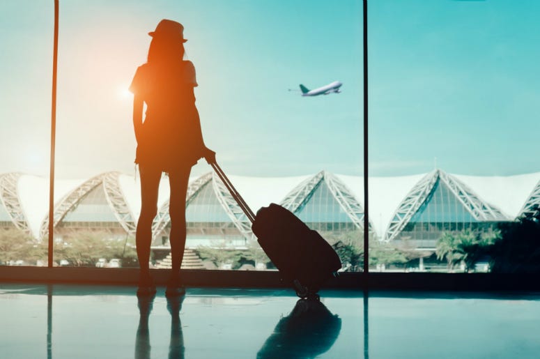 Fashionably Flying Silhouette woman travel with luggage looking without window at airport terminal international or girl teenager traveling in vacation