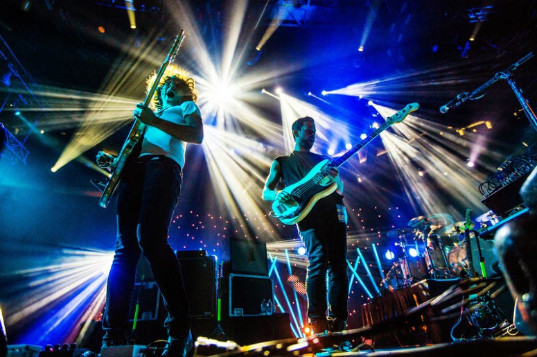 SEATTLE - SEPTEMBER 3, 2012: Synth pop band M83 performs on stage at Key Arena in Seattle during the music festival Bumbershoot on September 3, 2012. SEATTLE - SEPTEMBER 3, 2012: Synth pop band M83 performs on stage at Key Arena in Seattle during the music festival Bumbershoot on September 3, 2012.