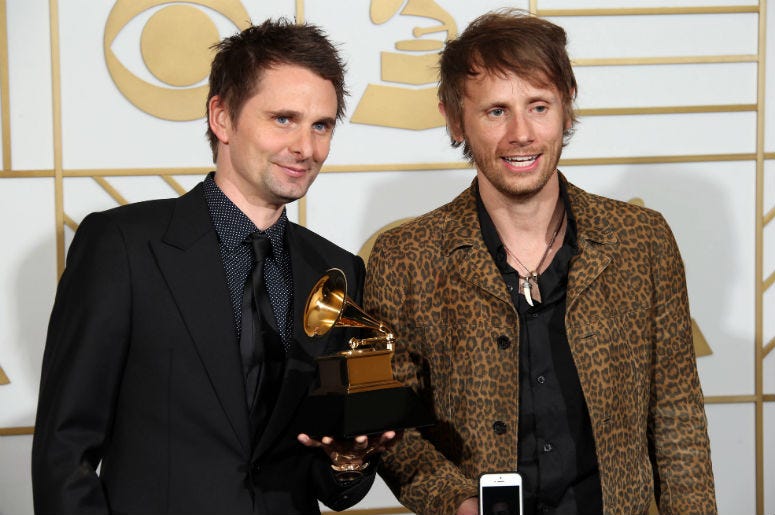 Matt Bellamy (left) and Dominic Howard of Muse pose in the photo room with their award for Best Rock Album for Drones during the 58th Grammy Awards at the Staples Center Matt Bellamy (left) and Dominic Howard of Muse pose in the photo room with their award for Best Rock Album for Drones during the 58th Grammy Awards at the Staples Center