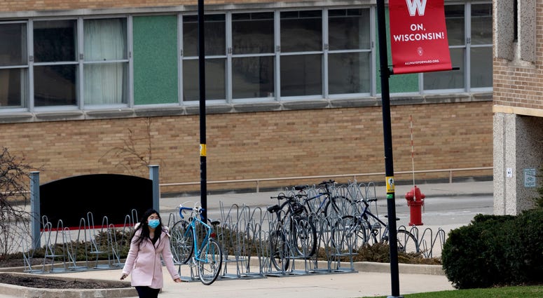 A UW-Madison student walks on an empty campus