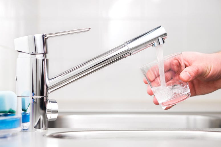 Filling glass with tap water. Modern faucet and sink. Filling glass with tap water. Modern faucet and sink.