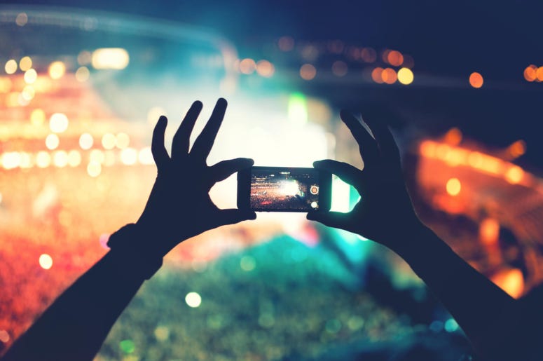 Silhouette of hands using camera phone to take pictures and videos at pop concert, festival Silhouette of hands using camera phone to take pictures and videos at pop concert, festival