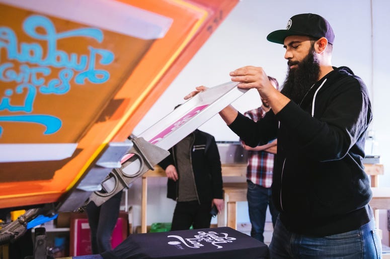 Keith printing shirts at Inker Prints