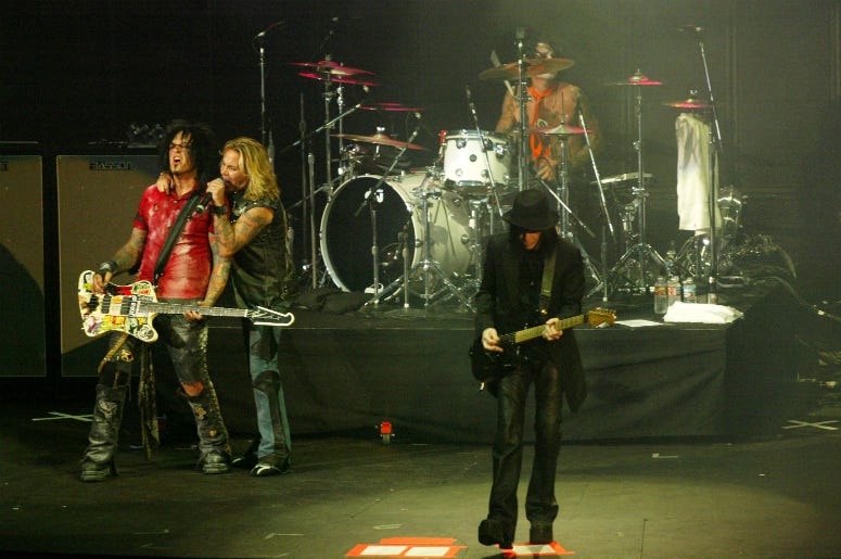 Bassist Nikki Sixx, lead singer Vince Neal, drummer Tommy Lee and guitarist Mick Mars of Motley Crue perform at the KROQ Weenie Roast 2005 Bassist Nikki Sixx, lead singer Vince Neal, drummer Tommy Lee and guitarist Mick Mars of Motley Crue perform at the KROQ Weenie Roast 2005