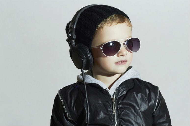 Kid listens to headphones Kid listens to headphones
