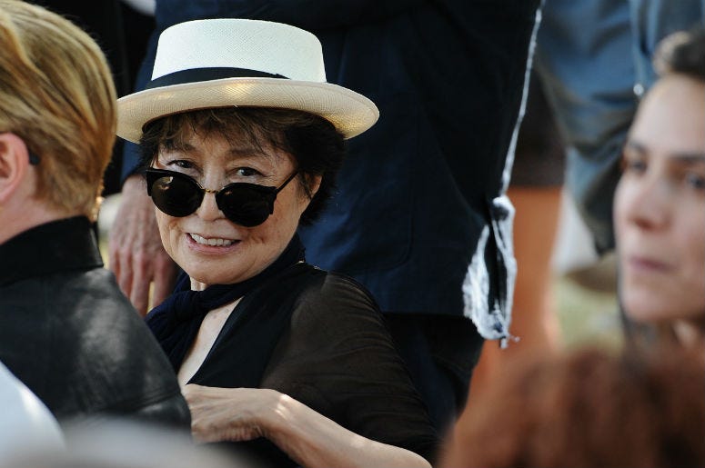 Yoko Ono attends the unveiling of the John Lennon Amnesty International tapestry at a ceremony near the American Immigrant Wall of Honor at the Ellis Island Nation Museum of Immigration in New York, NY, on July 29, 2015, on the 40th Anniversary of John Le Yoko Ono attends the unveiling of the John Lennon Amnesty International tapestry at a ceremony near the American Immigrant Wall of Honor at the Ellis Island Nation Museum of Immigration in New York, NY, on July 29, 2015, on the 40th Anniversary of John Le