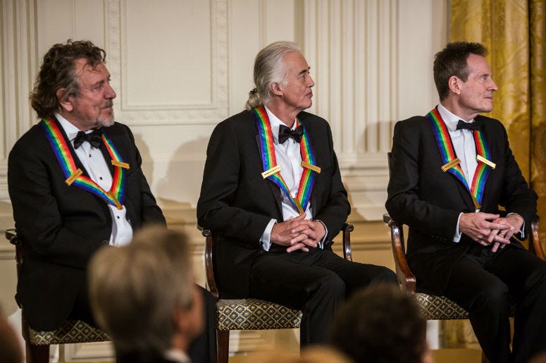 Robert Plant, Jimmy Page, and John Paul Jones (L-R) of the band Led Zeppelin attend the Kennedy Center Honors reception at the White House on December 2, 2012 in Washington, DC Robert Plant, Jimmy Page, and John Paul Jones (L-R) of the band Led Zeppelin attend the Kennedy Center Honors reception at the White House on December 2, 2012 in Washington, DC
