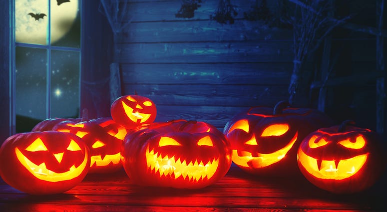 Spooky halloween background. scary pumpkin with burning eyes Spooky halloween background. scary pumpkin with burning eyes