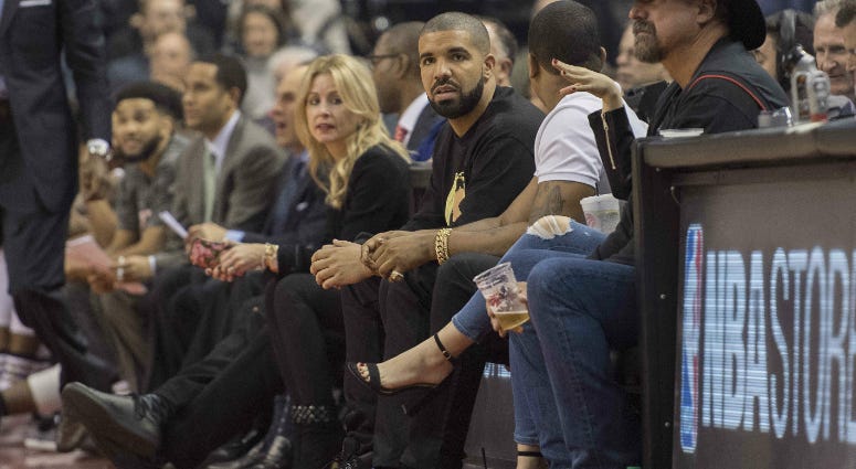 Canadian recording artist Drake watches the action during the first quarter in a game between the Golden State Warriors and the Toronto Raptors at Air Canada Centre. Canadian recording artist Drake watches the action during the first quarter in a game between the Golden State Warriors and the Toronto Raptors at Air Canada Centre.
