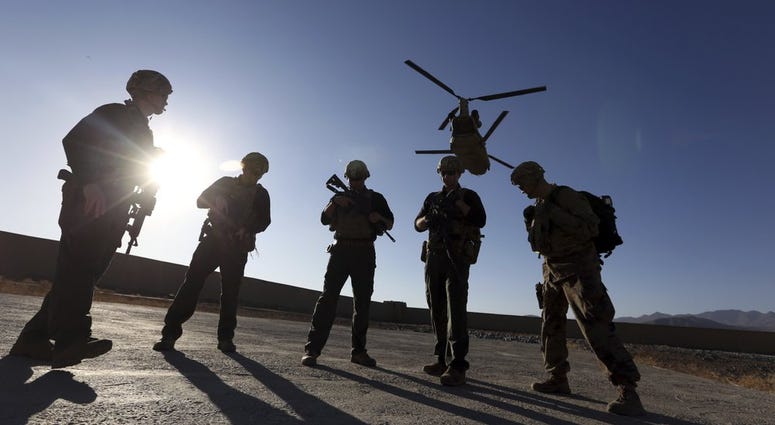 FILE - In this Nov. 30, 2017 file photo, American soldiers wait on the tarmac in Logar province, Afghanistan. Top officials in the White House were aware in early 2019 of classified intelligence indicating Russia was secretly offering bounties to the Tali