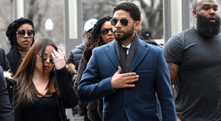 Empire actor Jussie Smollett, center, arrives at the Leighton Criminal Court Building for his hearing on Thursday, March 14, 2019, in Chicago. (AP Photo/Matt Marton)