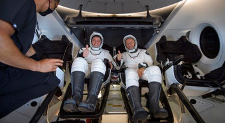 NASA astronauts Robert Behnken, left, and Douglas Hurley are seen inside the SpaceX Crew Dragon Endeavour spacecraft onboard the SpaceX GO Navigator recovery ship. (Bill Ingalls/NASA via AP) NASA astronauts Robert Behnken, left, and Douglas Hurley are seen inside the SpaceX Crew Dragon Endeavour spacecraft onboard the SpaceX GO Navigator recovery ship. (Bill Ingalls/NASA via AP)