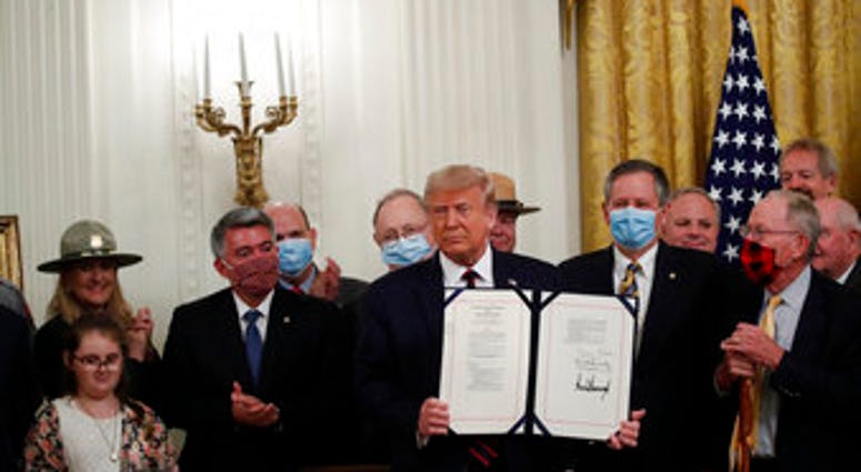 President Donald Trump poses for a photo during a signing ceremony for H.R. 1957 – "The Great American Outdoors Act," in the East Room of the White House, Tuesday, Aug. 4, 2020, in Washington. (AP Photo/Alex Brandon) President Donald Trump poses for a photo during a signing ceremony for H.R. 1957 – "The Great American Outdoors Act," in the East Room of the White House, Tuesday, Aug. 4, 2020, in Washington. (AP Photo/Alex Brandon)