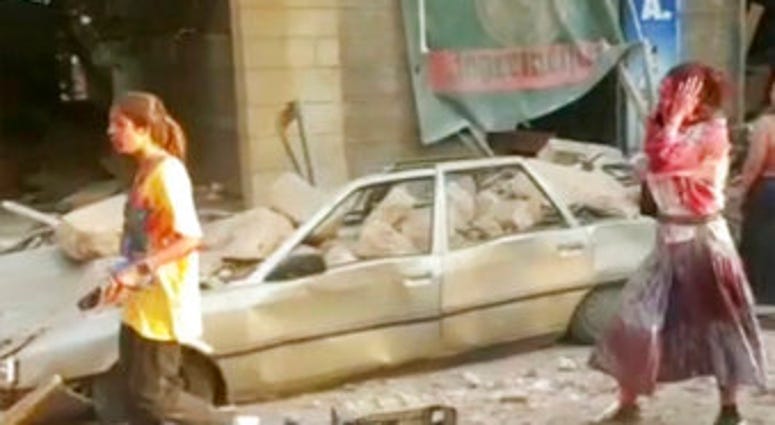 In this frame from video people walk down the street after an explosion in Beirut, Tuesday, Aug. 4, 2020. A massive explosion shook Lebanon's capital wounding a number people and causing widespread damage. (AP Photo) In this frame from video people walk down the street after an explosion in Beirut, Tuesday, Aug. 4, 2020. A massive explosion shook Lebanon's capital wounding a number people and causing widespread damage. (AP Photo)