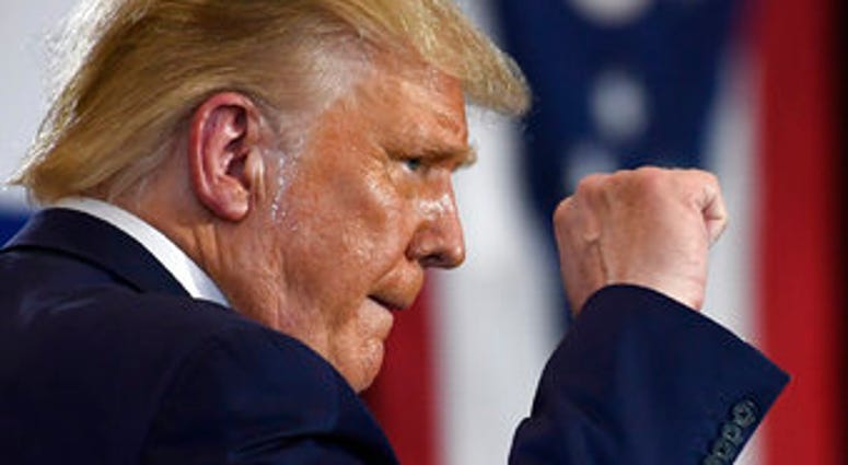 President Donald Trump pumps his fist as he finishes speaking during an event at the Whirlpool Corporation facility in Clyde, Ohio, Thursday, Aug. 6, 2020. (AP Photo/Susan Walsh) President Donald Trump pumps his fist as he finishes speaking during an event at the Whirlpool Corporation facility in Clyde, Ohio, Thursday, Aug. 6, 2020. (AP Photo/Susan Walsh)