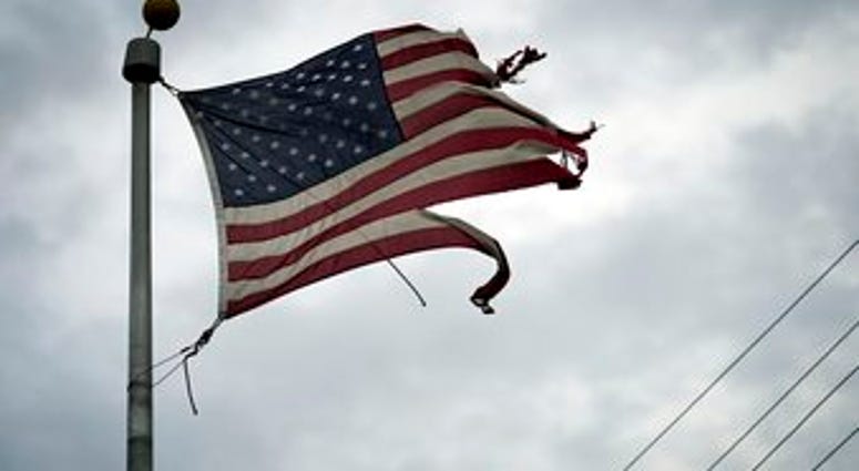 A tattered American flag blows in the wind in the aftermath of Hurricane Laura Thursday, Aug. 27, 2020, in Port Arthur, Texas. (AP Photo/Eric Gay) A tattered American flag blows in the wind in the aftermath of Hurricane Laura Thursday, Aug. 27, 2020, in Port Arthur, Texas. (AP Photo/Eric Gay)
