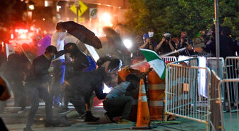 Police spray an irritant at demonstrators outside the Public Safety Building in Rochester, N.Y., Thursday, Sept. 3, 2020. (AP Photo/Adrian Kraus) Police spray an irritant at demonstrators outside the Public Safety Building in Rochester, N.Y., Thursday, Sept. 3, 2020. (AP Photo/Adrian Kraus)