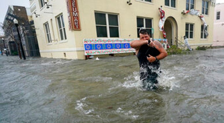 Trent Airhart wades through floodwaters, Wednesday, Sept. 16, 2020, in downtown Pensacola, Fla. (AP Photo/Gerald Herbert) Trent Airhart wades through floodwaters, Wednesday, Sept. 16, 2020, in downtown Pensacola, Fla. (AP Photo/Gerald Herbert)