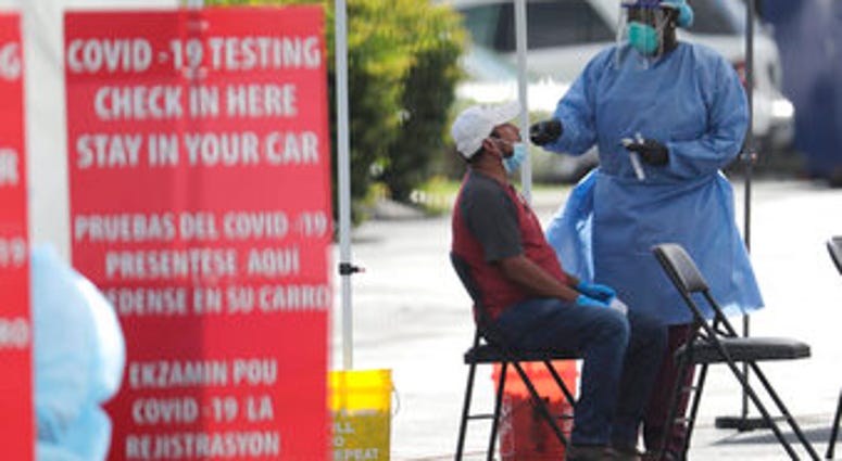 FILE - In this July 6, 2020 file photo, a health care worker administers a COVID-19 test at a site sponsored by Community Heath of South Florida at the Martin Luther King, Jr. Clinica Campesina Health Center in Homestead, Fla.(AP Photo/Lynne Sladky, File) FILE - In this July 6, 2020 file photo, a health care worker administers a COVID-19 test at a site sponsored by Community Heath of South Florida at the Martin Luther King, Jr. Clinica Campesina Health Center in Homestead, Fla.(AP Photo/Lynne Sladky, File)