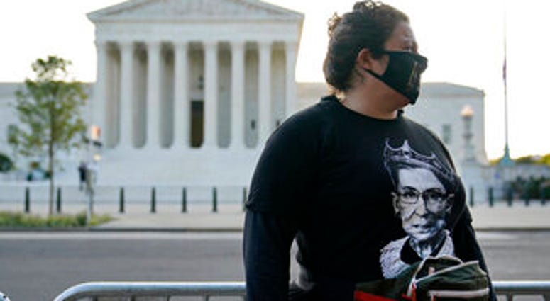Kara Stewart of Martin, Ky., stands outside the Supreme Court in Washington, Wednesday, Sept. 23, 2020, before a private ceremony and public viewing of Justice Ruth Bader Ginsburg. Ginsburg, 87, died of cancer on Sept. 18. (AP Photo/Patrick Semansky) Kara Stewart of Martin, Ky., stands outside the Supreme Court in Washington, Wednesday, Sept. 23, 2020, before a private ceremony and public viewing of Justice Ruth Bader Ginsburg. Ginsburg, 87, died of cancer on Sept. 18. (AP Photo/Patrick Semansky)