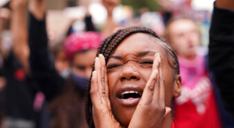 A woman speaks during a protest, Wednesday, Sept. 23, 2020, in Louisville, Ky. A grand jury has indicted one officer on criminal charges six months after Breonna Taylor was fatally shot by police in Kentucky. (AP Photo/John Minchillo) A woman speaks during a protest, Wednesday, Sept. 23, 2020, in Louisville, Ky. A grand jury has indicted one officer on criminal charges six months after Breonna Taylor was fatally shot by police in Kentucky. (AP Photo/John Minchillo)