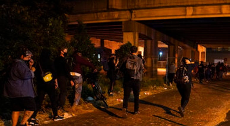 Protesters react to gunfire, Wednesday, Sept. 23, 2020, in Louisville, Ky. (AP Photo/John Minchillo) Protesters react to gunfire, Wednesday, Sept. 23, 2020, in Louisville, Ky. (AP Photo/John Minchillo)