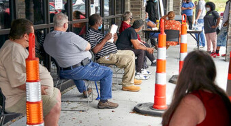 FILE - In this July 15, 2020, file photo, job seekers exercise social distancing as they wait to be called into the Heartland Workforce Solutions office in Omaha, Neb. (AP Photo/Nati Harnik, File) FILE - In this July 15, 2020, file photo, job seekers exercise social distancing as they wait to be called into the Heartland Workforce Solutions office in Omaha, Neb. (AP Photo/Nati Harnik, File)