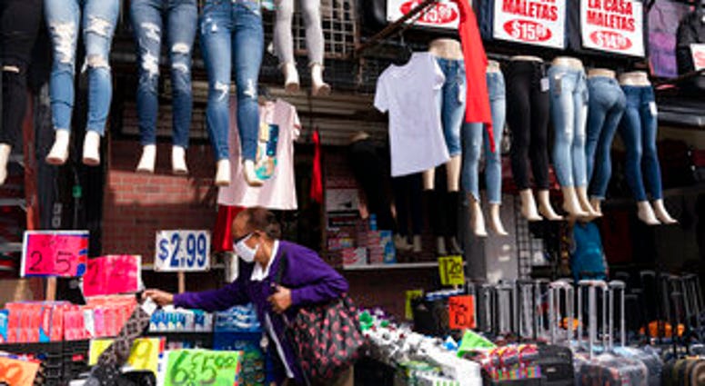 FILE - In this Sept. 25, 2020 file photo, a woman shops at a clothing store in New York. (AP Photo/Mark Lennihan, File) FILE - In this Sept. 25, 2020 file photo, a woman shops at a clothing store in New York. (AP Photo/Mark Lennihan, File)