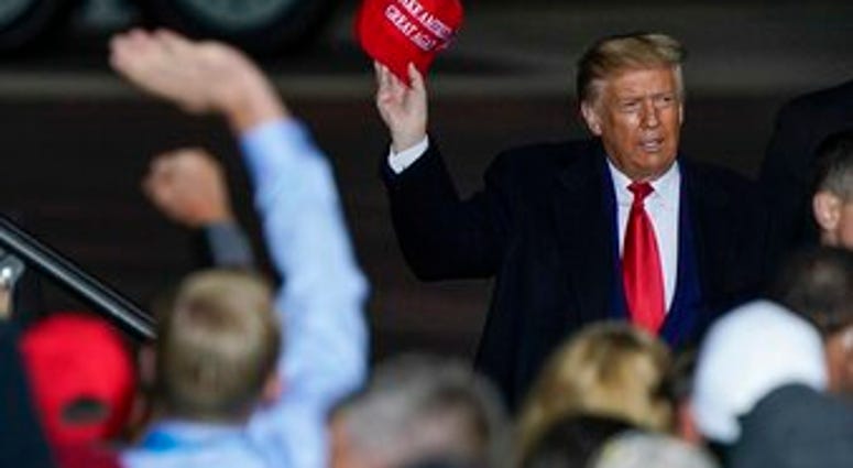 FILE - In this Sept. 17, 2020 file photo President Donald Trump throws a hat to the crowd after speaking at a campaign rally at the Central Wisconsin Airport in Mosinee, Wis. (AP Photo/Morry Gash, File) FILE - In this Sept. 17, 2020 file photo President Donald Trump throws a hat to the crowd after speaking at a campaign rally at the Central Wisconsin Airport in Mosinee, Wis. (AP Photo/Morry Gash, File)