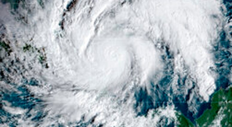 This GeoColor satellite image taken Tuesday, Nov. 3, 2020, and provided by NOAA, shows Hurricane Eta in the Caribbean Sea, arriving at Nicaragua's northern shore. Eta inched closer on Tuesday as a Category 4 storm. (NOAA via AP) This GeoColor satellite image taken Tuesday, Nov. 3, 2020, and provided by NOAA, shows Hurricane Eta in the Caribbean Sea, arriving at Nicaragua's northern shore. Eta inched closer on Tuesday as a Category 4 storm. (NOAA via AP)
