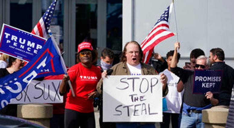 Supports of President Donald Trump holds signs during a demonstration outside the State Farm Arena where Fulton County has a voting counting operation, Thursday, Nov. 5, 2020, in Atlanta. (AP Photo/John Bazemore) Supports of President Donald Trump holds signs during a demonstration outside the State Farm Arena where Fulton County has a voting counting operation, Thursday, Nov. 5, 2020, in Atlanta. (AP Photo/John Bazemore)