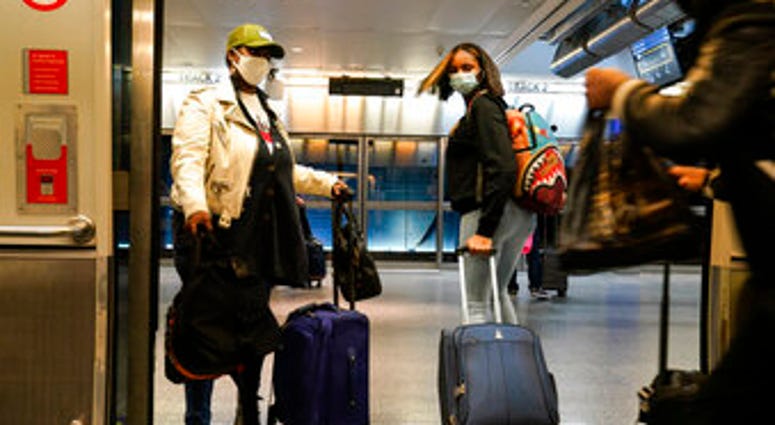 Travelers leave the AirTrain at JFK International Airport Friday, Nov. 20, 2020, in New York. (AP Photo/Frank Franklin II) Travelers leave the AirTrain at JFK International Airport Friday, Nov. 20, 2020, in New York. (AP Photo/Frank Franklin II)