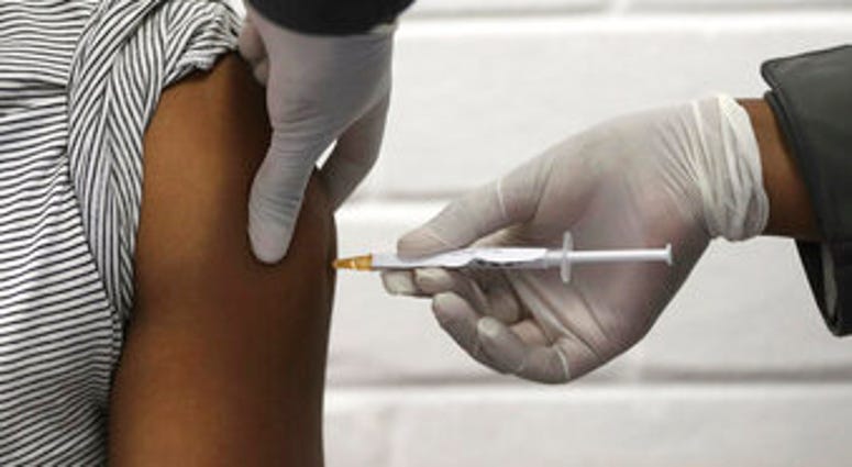 FILE - In this Wednesday, June 24, 2020 file photo, a volunteer receives an injection at the Chris Hani Baragwanath hospital in Soweto, Johannesburg, as part of Africa's first participation in a COVID-19 vaccine trial. (Siphiwe Sibeko/Pool via AP) FILE - In this Wednesday, June 24, 2020 file photo, a volunteer receives an injection at the Chris Hani Baragwanath hospital in Soweto, Johannesburg, as part of Africa's first participation in a COVID-19 vaccine trial. (Siphiwe Sibeko/Pool via AP)