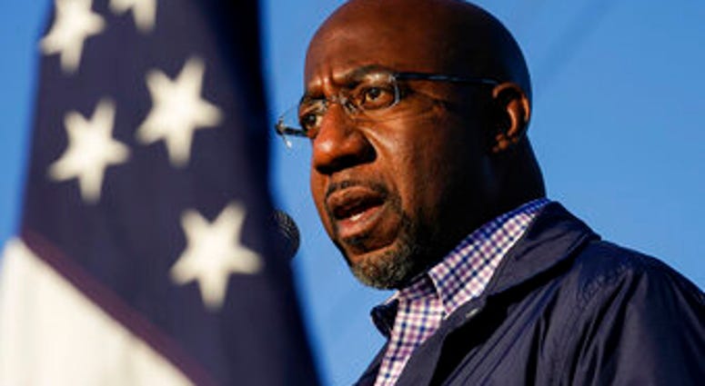 FILE - In this Nov. 15, 2020, file photo Raphael Warnock, a Democratic candidate for the U.S. Senate, speaks during a campaign rally in Marietta, Ga. (AP Photo/Brynn Anderson, File) FILE - In this Nov. 15, 2020, file photo Raphael Warnock, a Democratic candidate for the U.S. Senate, speaks during a campaign rally in Marietta, Ga. (AP Photo/Brynn Anderson, File)