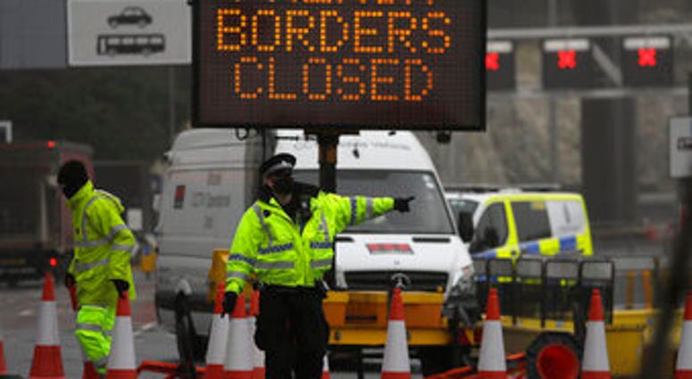 A police officer directs traffic at the entrance to the closed ferry terminal in Dover, England, Monday, Dec. 21, 2020. (AP Photo/Kirsty Wigglesworth) A police officer directs traffic at the entrance to the closed ferry terminal in Dover, England, Monday, Dec. 21, 2020. (AP Photo/Kirsty Wigglesworth)
