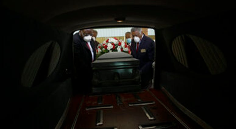 FILE - In this Saturday, April 18, 2020 file photo, a casket is placed into a hearse. (AP Photo/Brynn Anderson) FILE - In this Saturday, April 18, 2020 file photo, a casket is placed into a hearse. (AP Photo/Brynn Anderson)