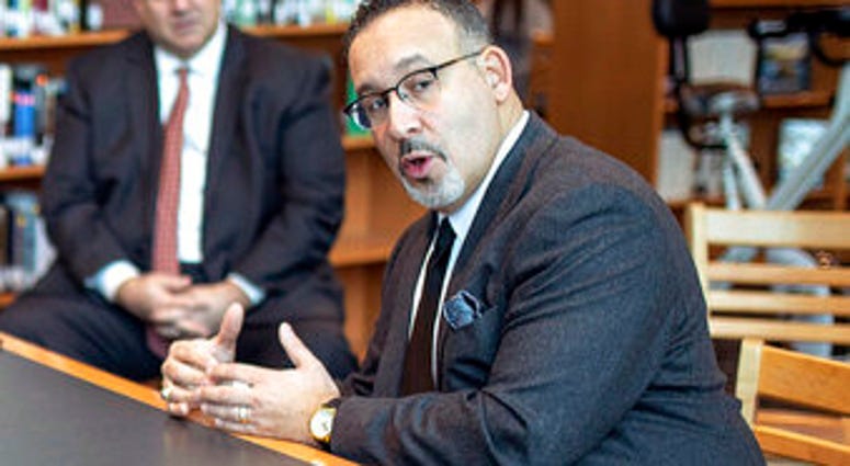 FILE - In this Jan. 28, 2020 file photo, Connecticut State Commissioner of Education Miguel Cardona speaks with Berlin High School students while on a tour of the school. (Devin Leith-Yessian/Berlin Citizen/Record-Journal via AP) FILE - In this Jan. 28, 2020 file photo, Connecticut State Commissioner of Education Miguel Cardona speaks with Berlin High School students while on a tour of the school. (Devin Leith-Yessian/Berlin Citizen/Record-Journal via AP)