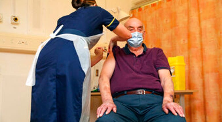 82-year-old Brian Pinker receives the Oxford University/AstraZeneca COVID-19 vaccine from nurse Sam Foster at the Churchill Hospital in Oxford, England, Monday, Jan. 4, 2021. (Steve Parsons/Pool Photo via AP) 82-year-old Brian Pinker receives the Oxford University/AstraZeneca COVID-19 vaccine from nurse Sam Foster at the Churchill Hospital in Oxford, England, Monday, Jan. 4, 2021. (Steve Parsons/Pool Photo via AP)
