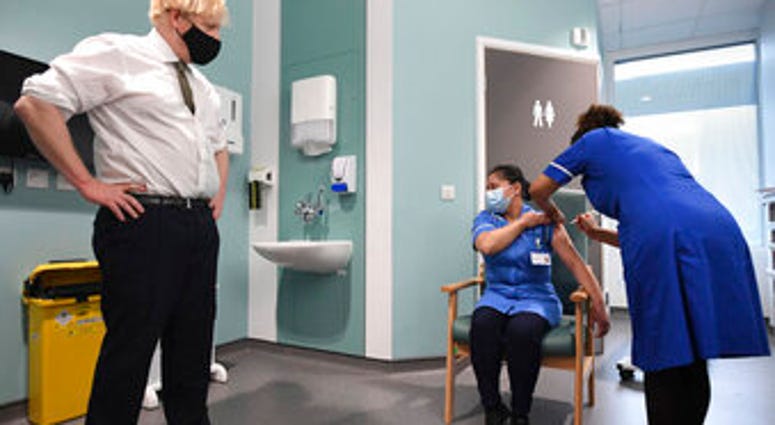Britain's Prime Minister Boris Johnson watches as nurse Jennifer Dumasi is injected with the Oxford-AstraZeneca Covid-19 vaccine. (Stefan Rousseau/Pool Photo via AP) Britain's Prime Minister Boris Johnson watches as nurse Jennifer Dumasi is injected with the Oxford-AstraZeneca Covid-19 vaccine. (Stefan Rousseau/Pool Photo via AP)