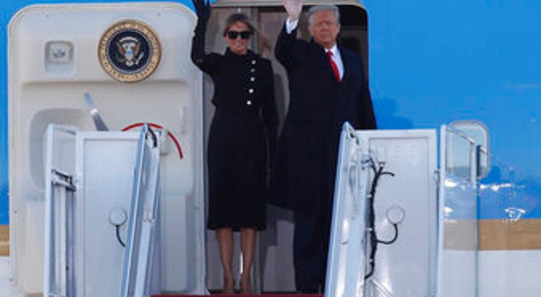 President Donald Trump and first lady Melania Trump wave to a crowd as they board Air Force One at Andrews Air Force Base, Md., Wednesday, Jan. 20, 2021. (AP Photo/Luis M. Alvarez) President Donald Trump and first lady Melania Trump wave to a crowd as they board Air Force One at Andrews Air Force Base, Md., Wednesday, Jan. 20, 2021. (AP Photo/Luis M. Alvarez)