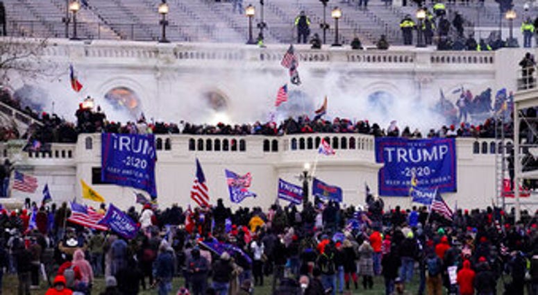 FILE - In this Jan. 6, 2021, file photo violent rioters, loyal to President Donald Trump, storm the Capitol in Washington. (AP Photo/John Minchillo, File) FILE - In this Jan. 6, 2021, file photo violent rioters, loyal to President Donald Trump, storm the Capitol in Washington. (AP Photo/John Minchillo, File)