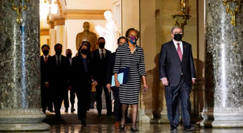 Clerk of the House Cheryl Johnson along with acting House Sergeant-at-Arms Tim Blodgett, lead the Democratic House impeachment managers as they walk through Statuary Hall in the Capitol. (AP Photo/Susan Walsh) Clerk of the House Cheryl Johnson along with acting House Sergeant-at-Arms Tim Blodgett, lead the Democratic House impeachment managers as they walk through Statuary Hall in the Capitol. (AP Photo/Susan Walsh)