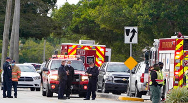 Law enforcement officers block an area where a shooting wounded several FBI while serving an arrest warrant, Tuesday, Feb. 2, 2021, in Sunrise, Fla. (AP Photo/Marta Lavandier) Law enforcement officers block an area where a shooting wounded several FBI while serving an arrest warrant, Tuesday, Feb. 2, 2021, in Sunrise, Fla. (AP Photo/Marta Lavandier)