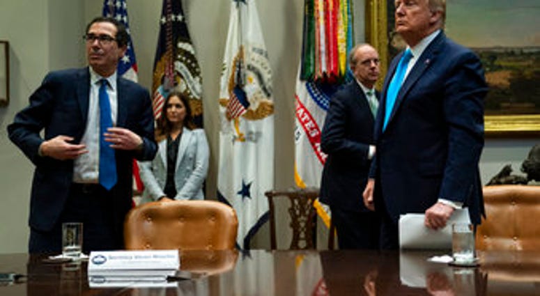 Treasury Secretary Steven Mnuchin and President Donald Trump listen to a question during a conference call with banks on efforts to help small businesses during the coronavirus pandemic. (AP Photo/Evan Vucci) Treasury Secretary Steven Mnuchin and President Donald Trump listen to a question during a conference call with banks on efforts to help small businesses during the coronavirus pandemic. (AP Photo/Evan Vucci)
