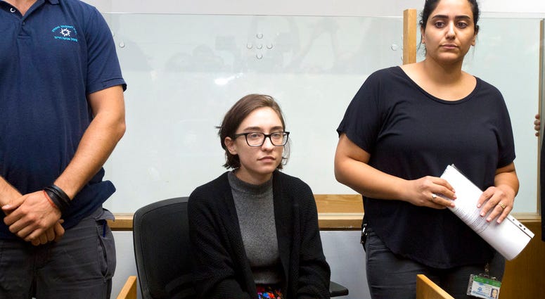 File - In this Thursday, Oct. 11, 2018 file photo, American Lara Alqasem, center, sits in a courtroom prior to a hearing at the district court in Tel Aviv, Israel. (AP Photo/Sebastian. Scheiner, File)