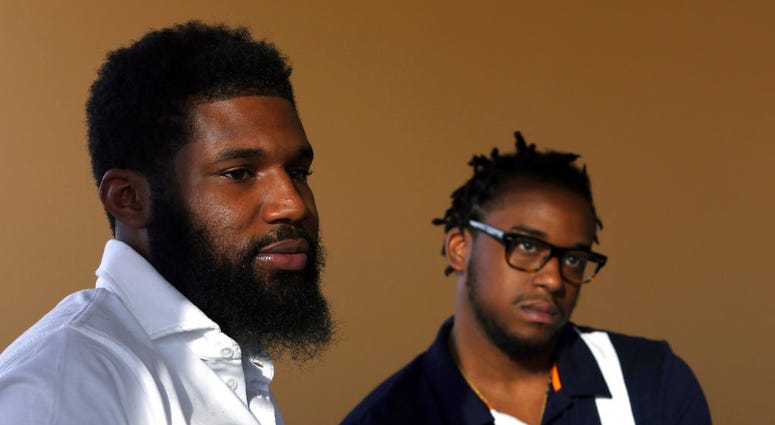 Rashon Nelson, left, and Donte Robinson, right, both 23, listen to a reporter's question during an interview with The Associated Press in Philadelphia. (AP Photo/Jacqueline Larma, File)