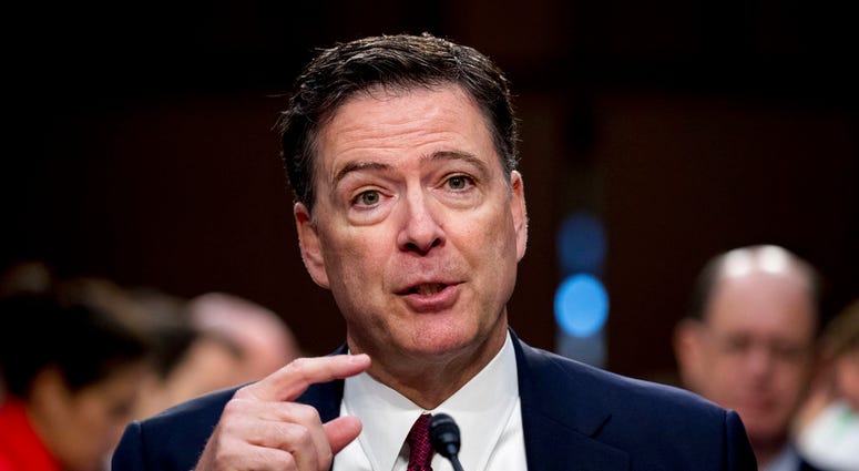 FILE - In this June 8, 2017 file photo, former FBI director James Comey speaks during a Senate Intelligence Committee hearing on Capitol Hill in Washington. Rudy Giuliani, Trump's new attorney, says Trump fired Comey last year "because Comey would not, am
