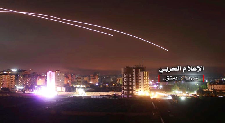 This photo provided early Thursday, May 10, 2018, by the government-controlled Syrian Central Military Media, shows missiles rise into the sky in Damascus, Syria. (Syrian Central Military Media, via AP)